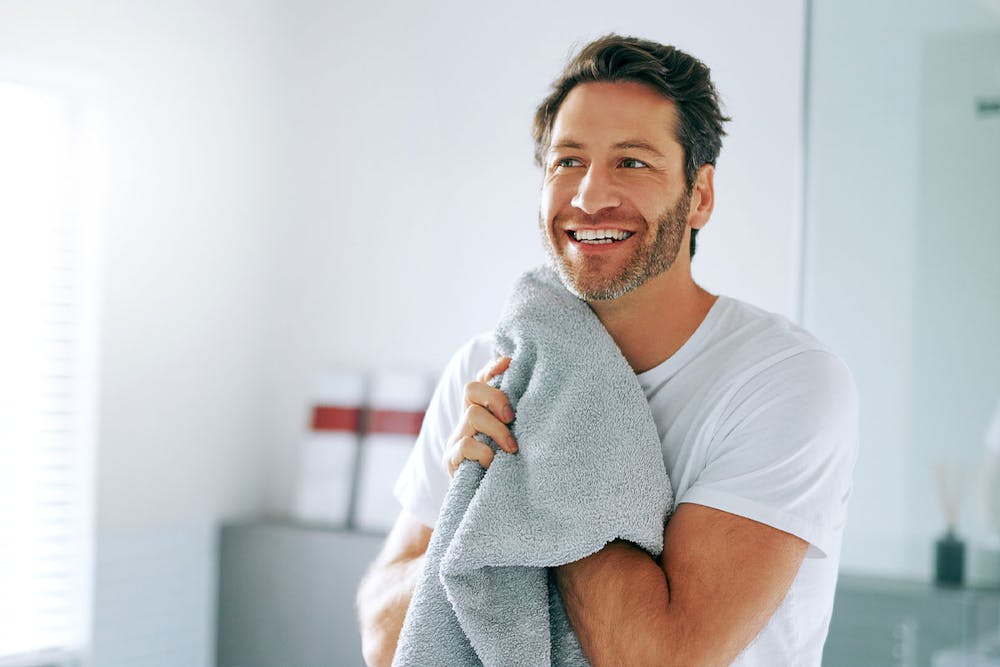 man after washing his hair after his hair transplant in Miami, FL