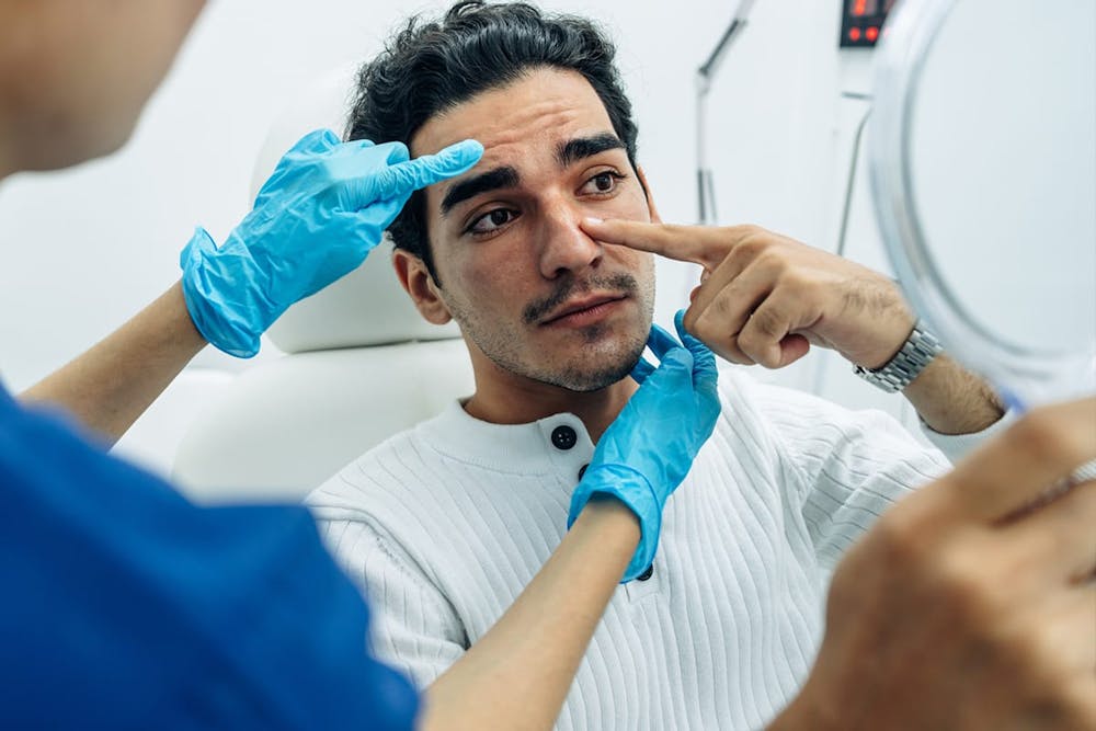 man getting a rhinoplasty consultation in Miami, FL
