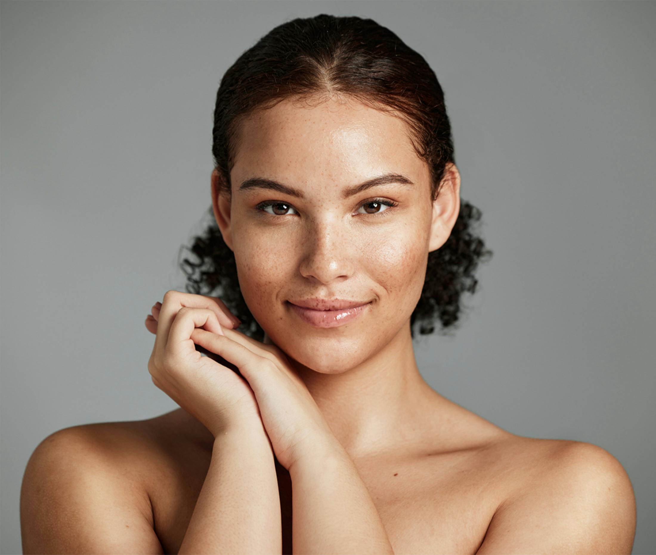 women holding her hands next to her face