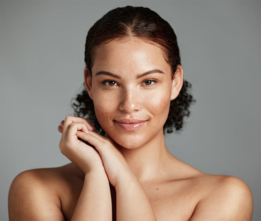 women holding her hands next to her face