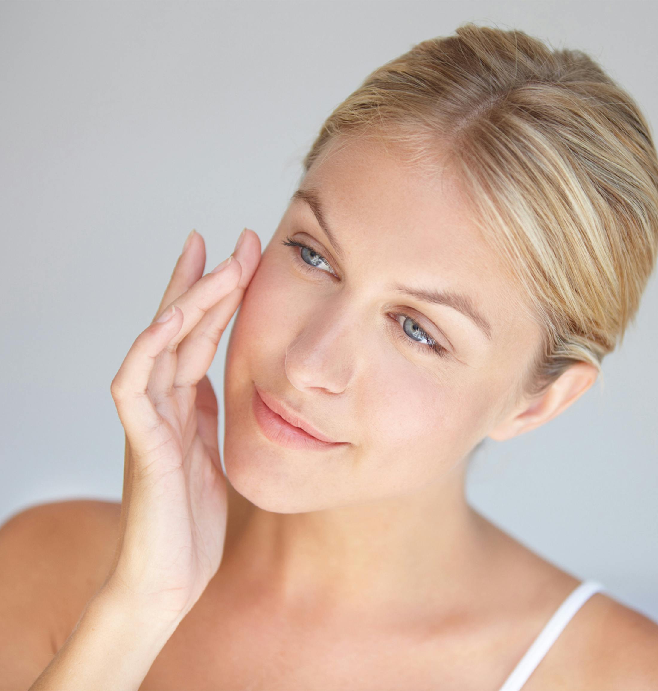 A woman touching her face