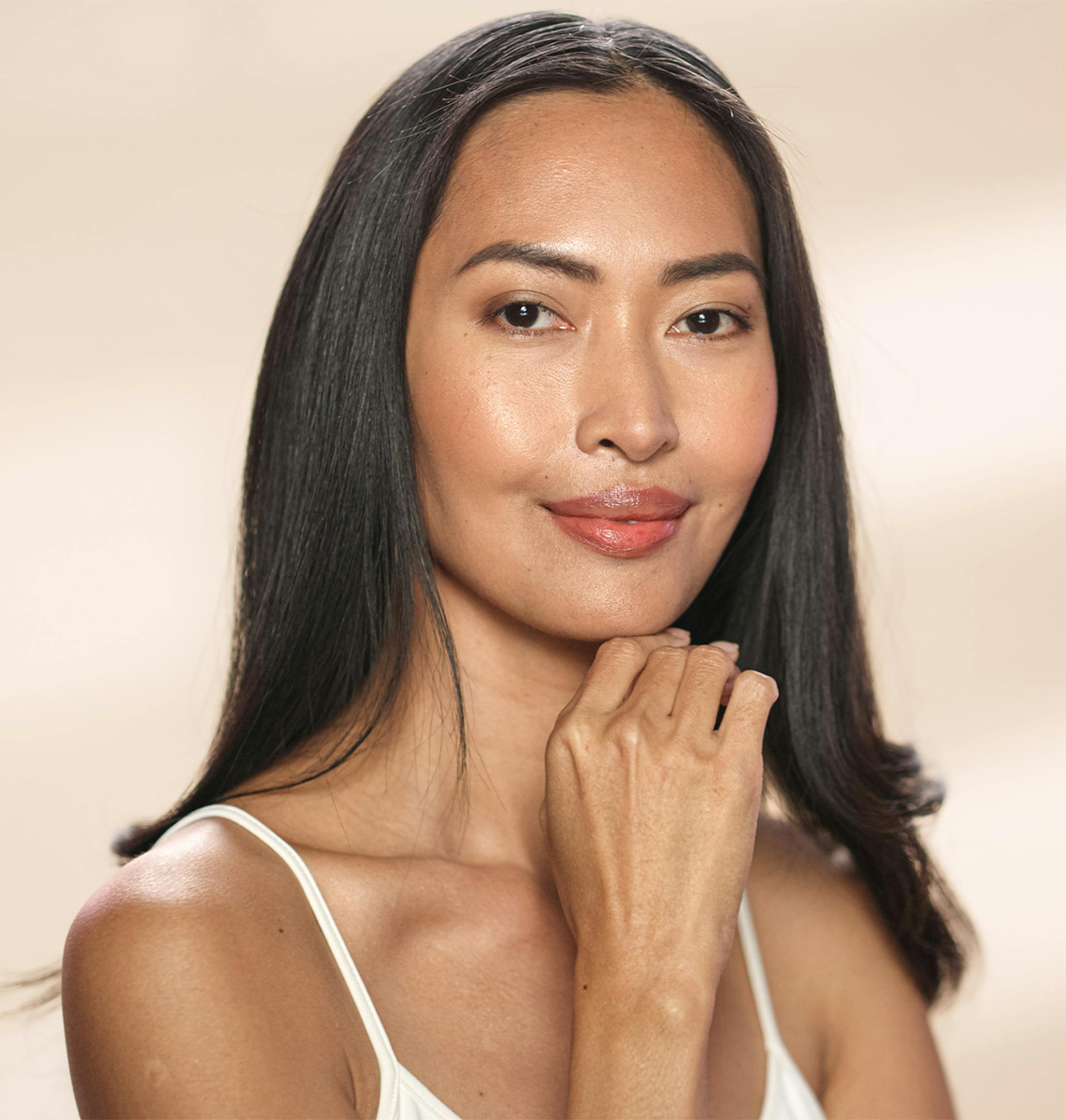 Woman smiling and touching her chin