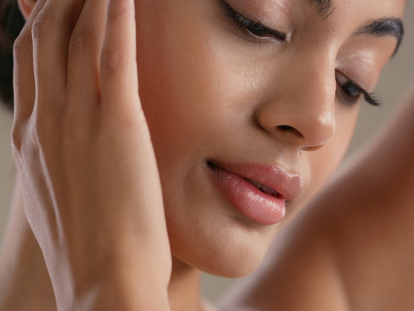 Woman touching her face