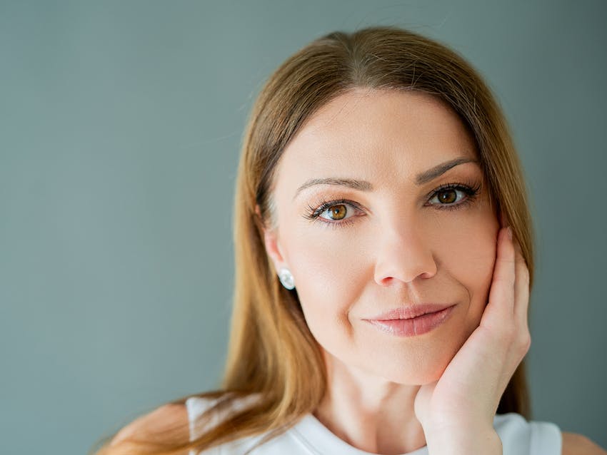 Woman touching her face