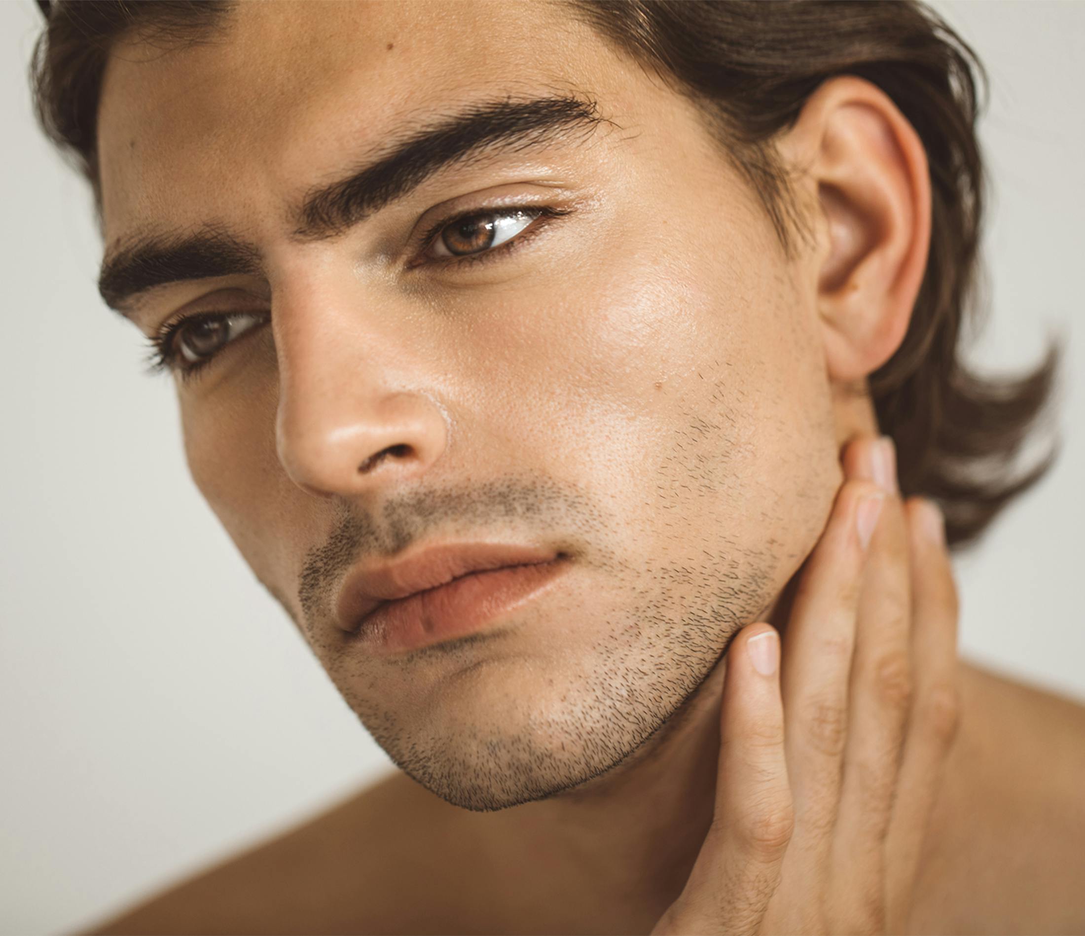 Man touching his neck