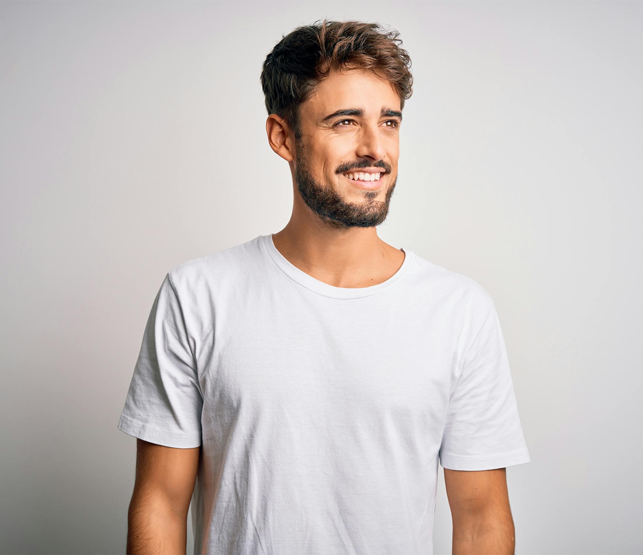 man smiling and looking off to the side