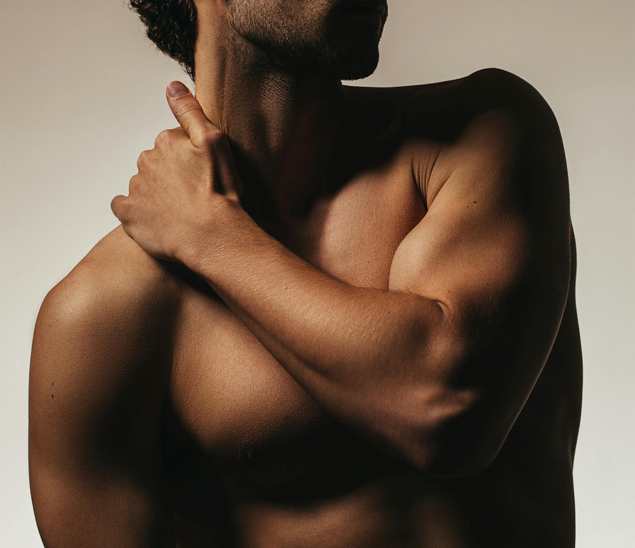 Man touching his shoulder