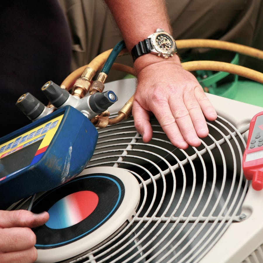 plumber working on fan