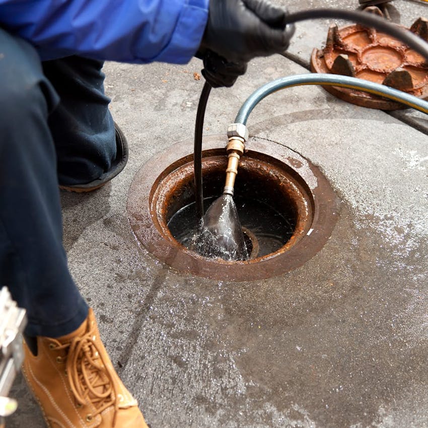 plumber with hose