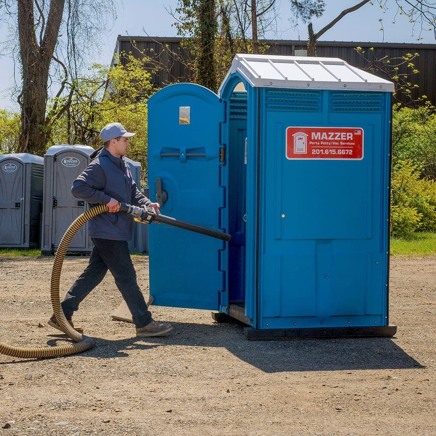 plumber emptying porta potty