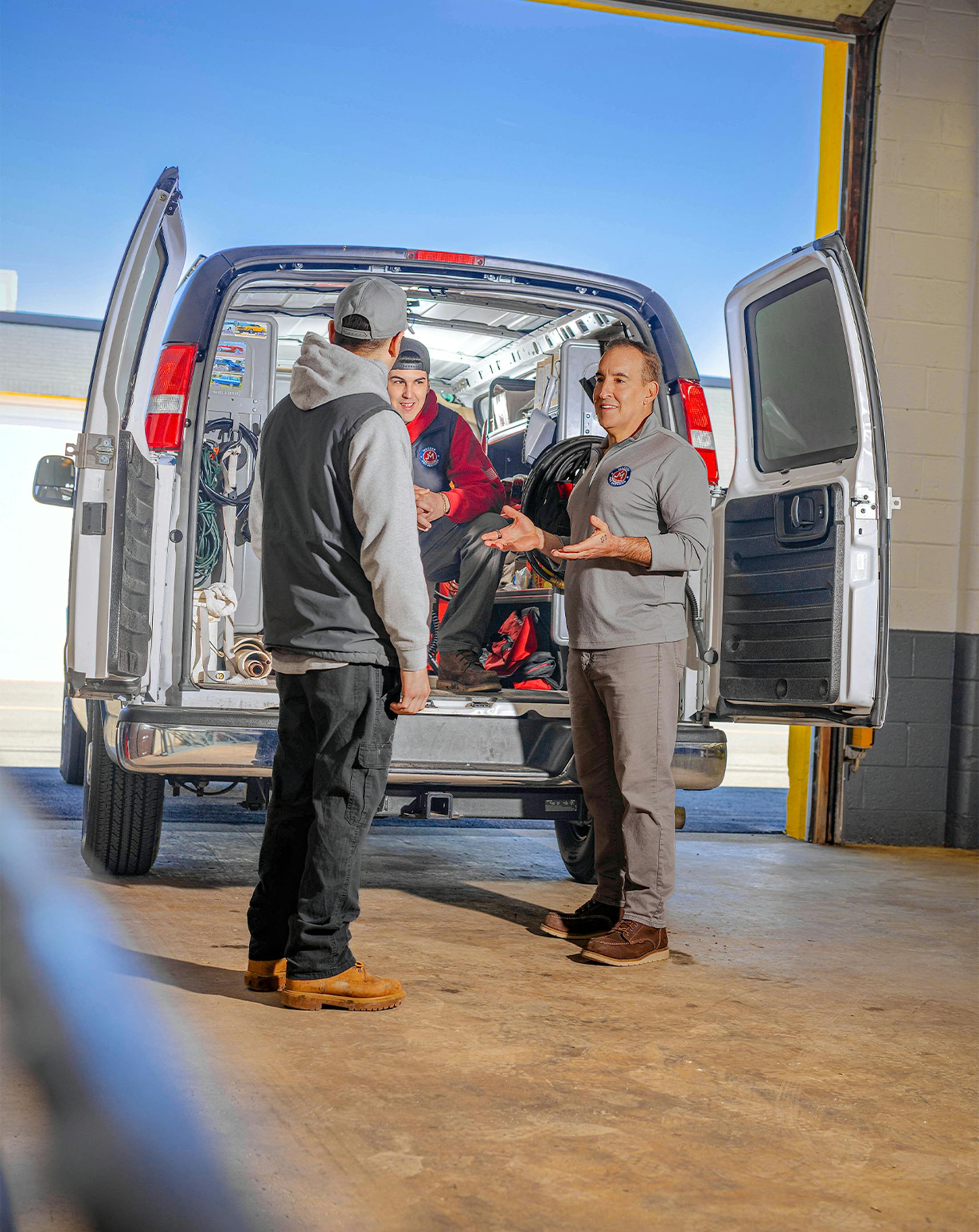 group of employees around the mazzer van