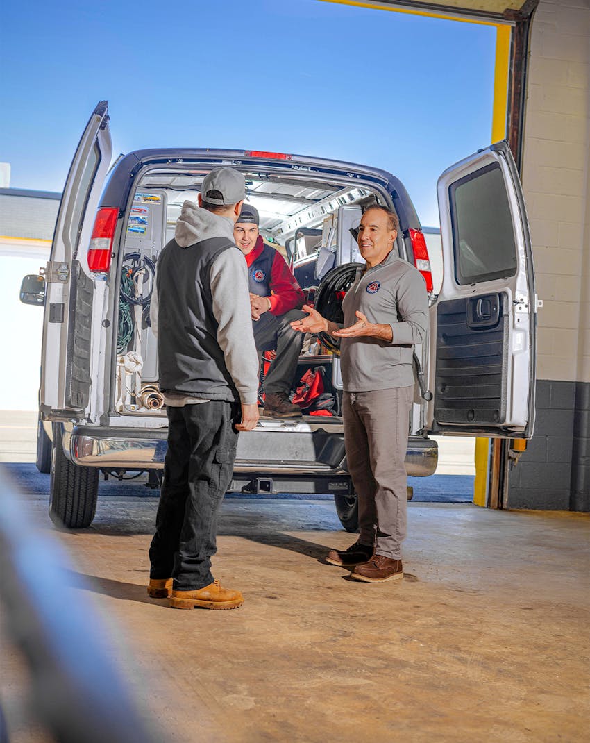 group of employees around the mazzer van