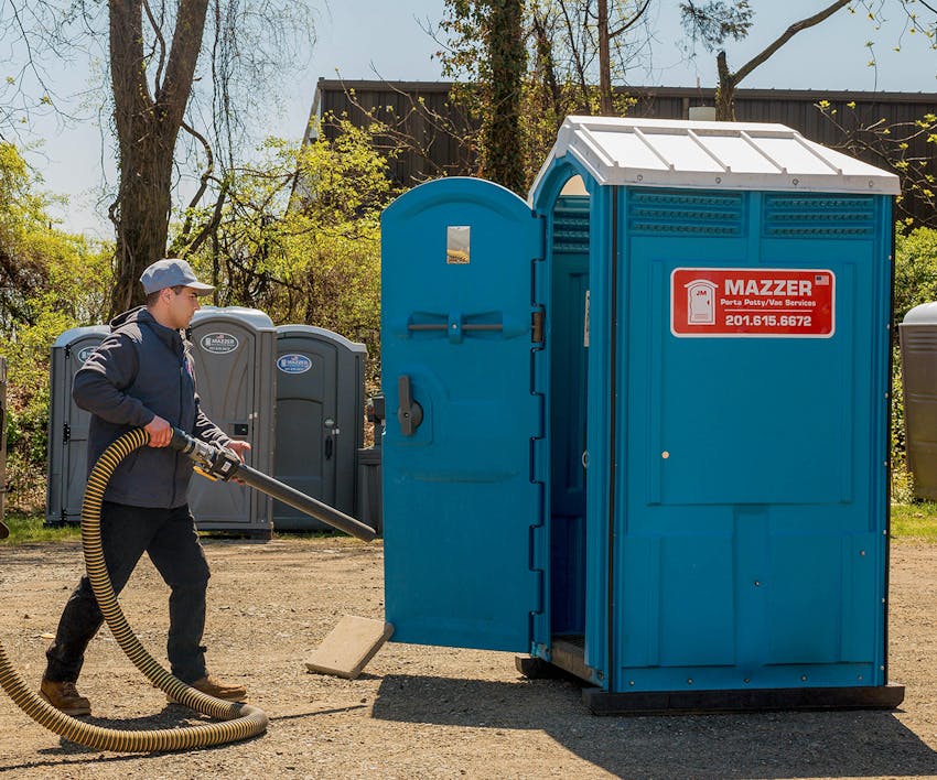 employee working on a portable bathroom