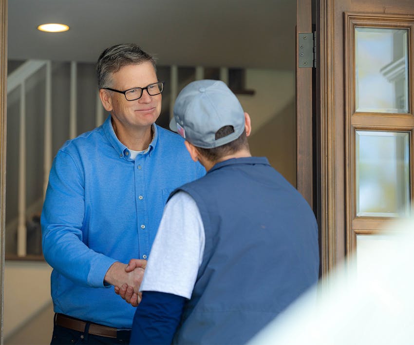 Employee shaking a client's hand