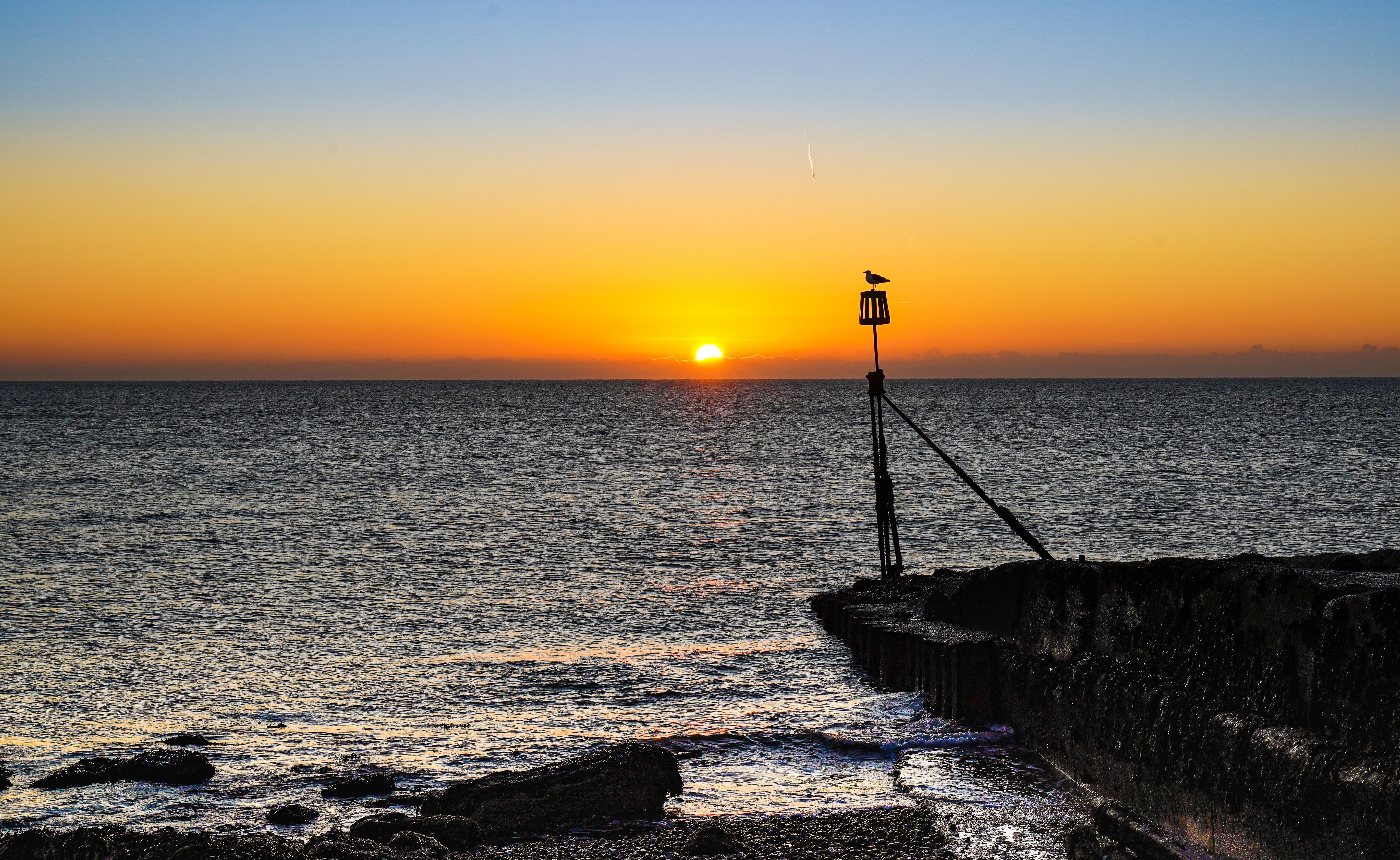 Image of the sun rising over the horizon from Selsey Bill Beach