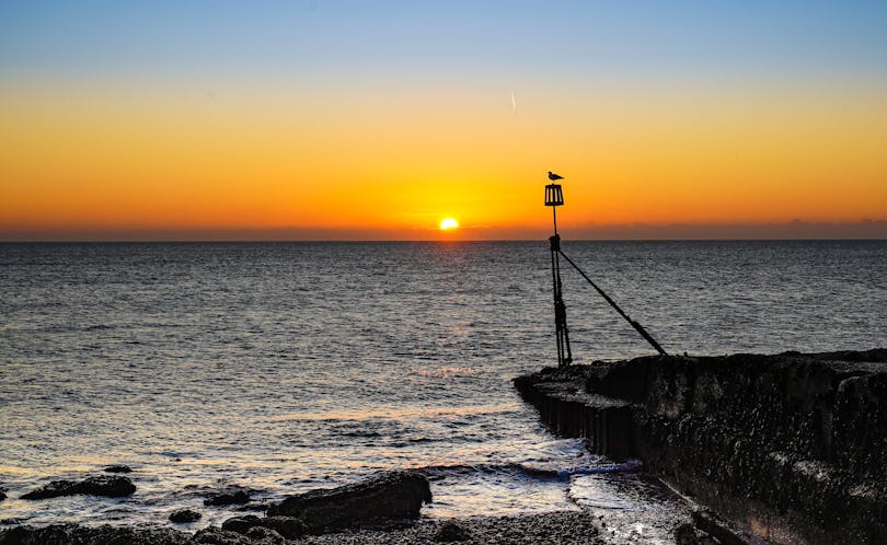 Sunrise at Selsey Bill  Image of the sun rising over the horizon from Selsey Bill Beach