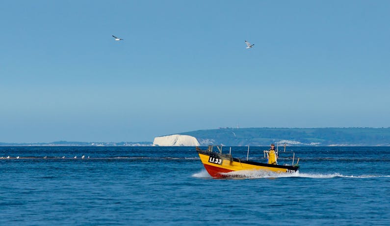 Isle of Wight Viewed from Marine Beach Image of a boat from Marine Beach at Selsey with the Isle of Wight in the distance