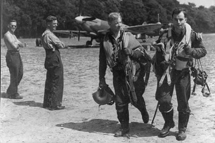 Image of pilots on the RAF Selsey airfield from June 1944 with spitfire in the background