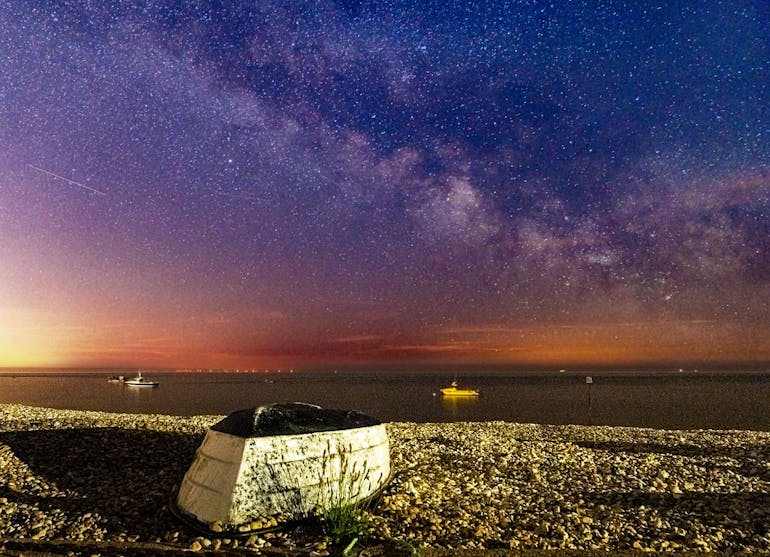 Milky Way captured over East Beach, courtesy of CoastalJJ Milkyway captured over East Beach with a overturned boat on the shingle in the foreground