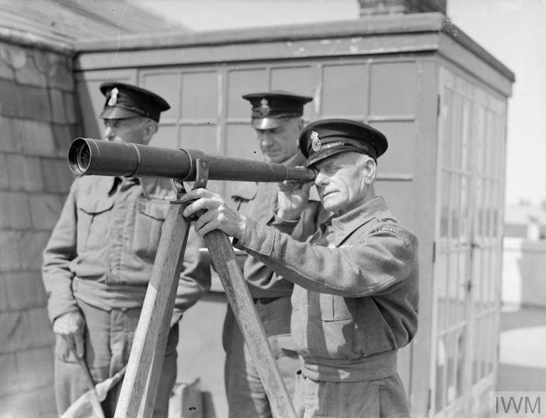 The Auxiliary Patrol of HM Coastguards, Selsey 1943 Station officer William Atkinson, who is in charge of Selsey's strip of coastline, examines a distant vessel through his telescope.