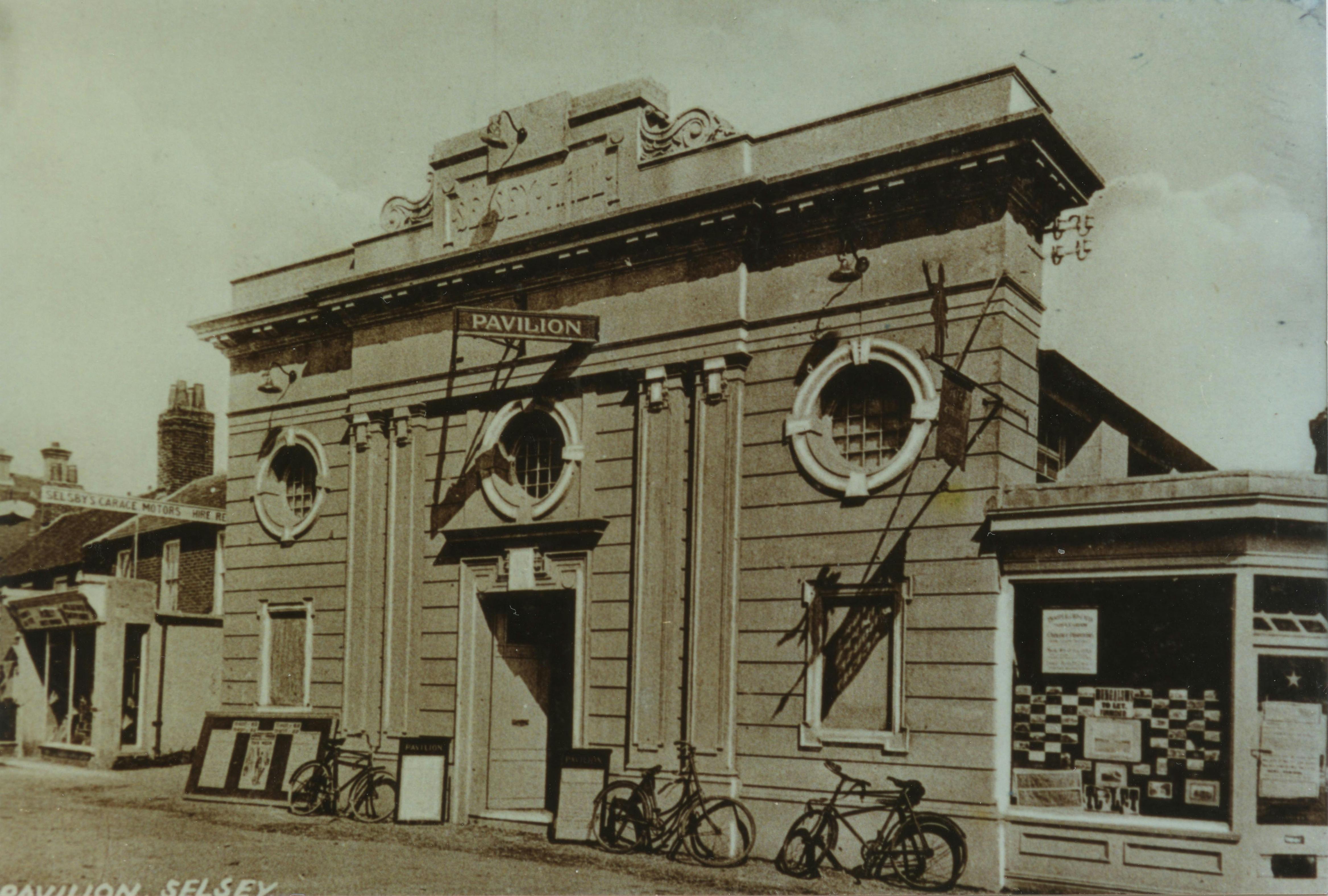 Image of the Selsey Pavilion taken in the High Street during the war years with bicycles leaning against the builiding