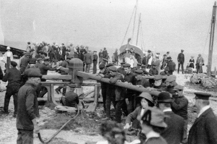 Black and White image of the fishermen using a huge winch for the Lifeboat 