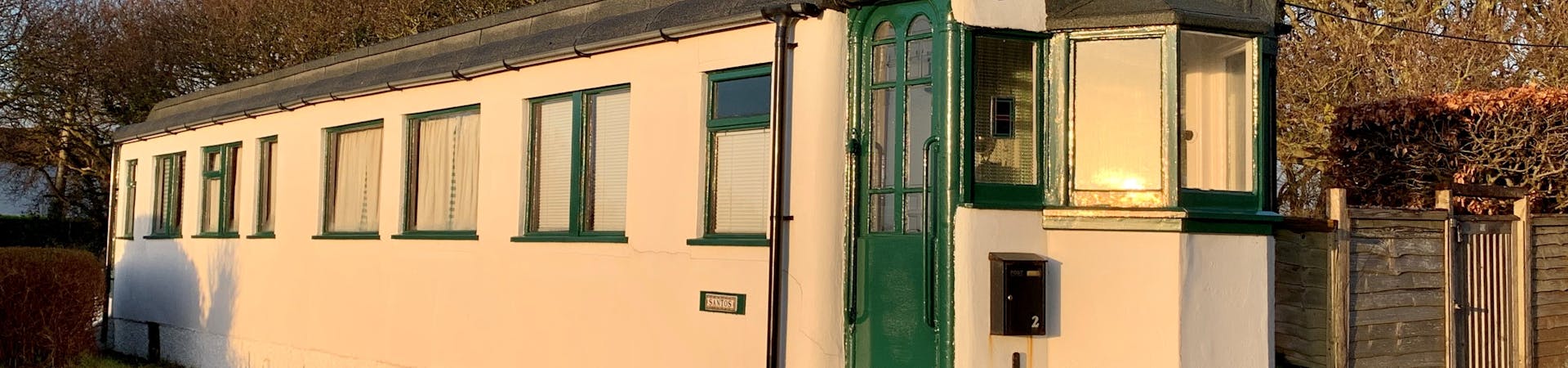House made out of one railway carriage and rendered in concrete.