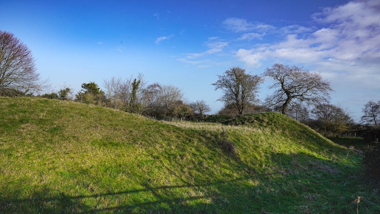 Grass mound marking the original existance of a fort at Church Norton 