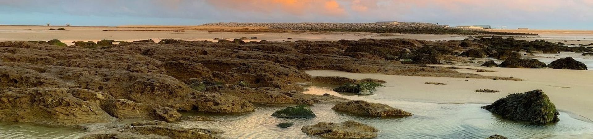 Clouds alight with the orange sun at suset over RSPB Medmerry Beach