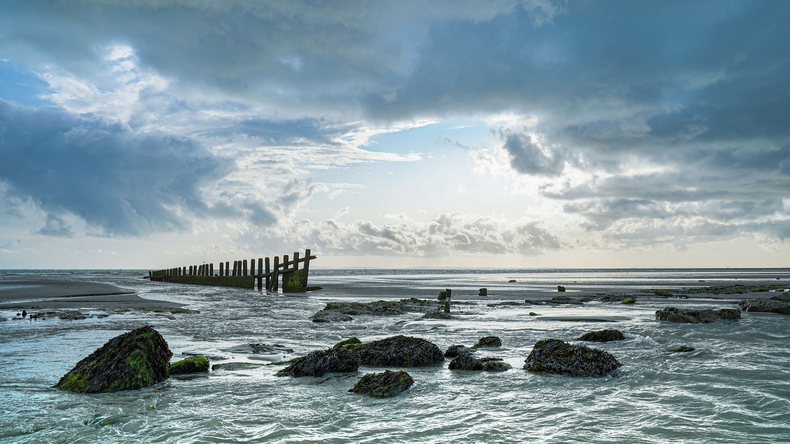 Medmerry beach with the tide out on a cloudy day 