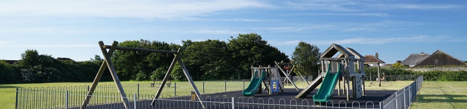 Image of the playground at Hillfield with swings, sides and climbing frame