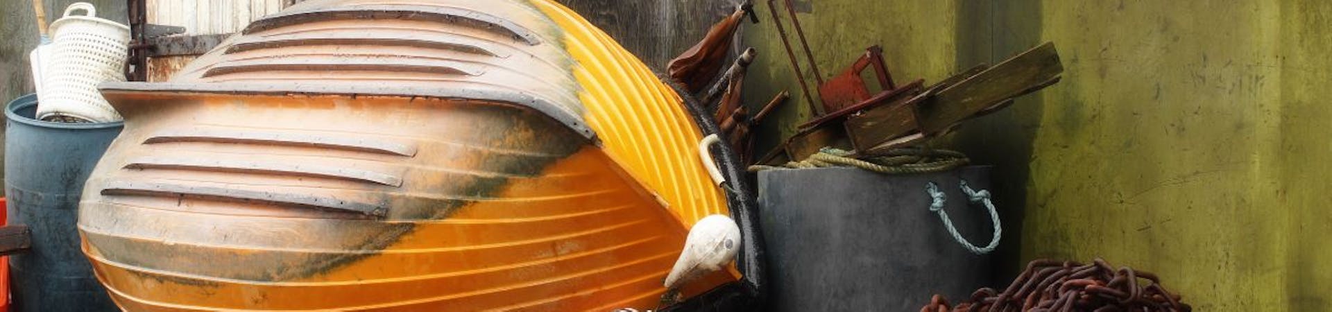 Yellow boat in front of the fishing huts at East Beach
