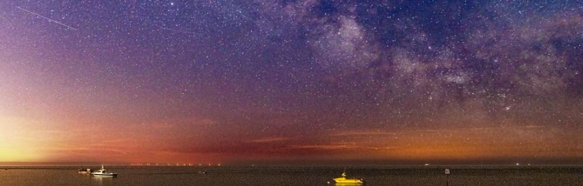 The Milky Way showing in the skies above the sea at East Beach 