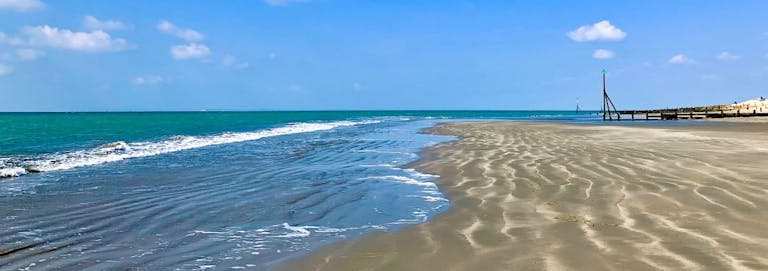 The tide out at Oval Field Beach revealing a sandy stretch