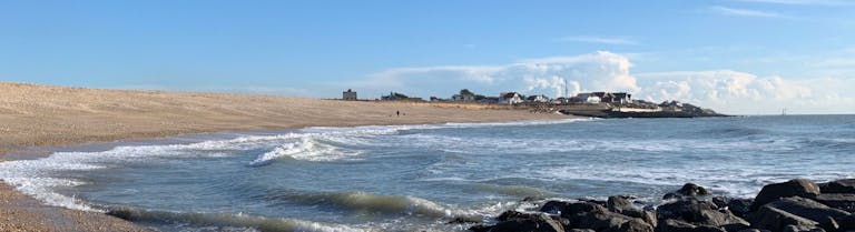 the curve of the beach sweeping around