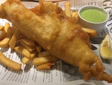 Battered cod, chips, mushy peas and a wedge of lemon