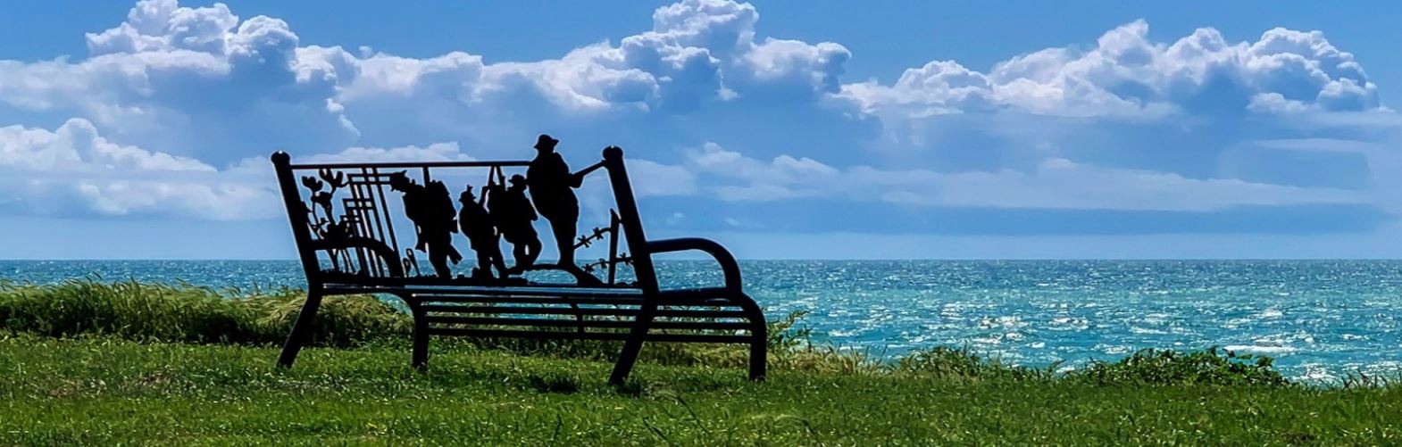 Bench for the fallen placed on Oval Field looking towards France