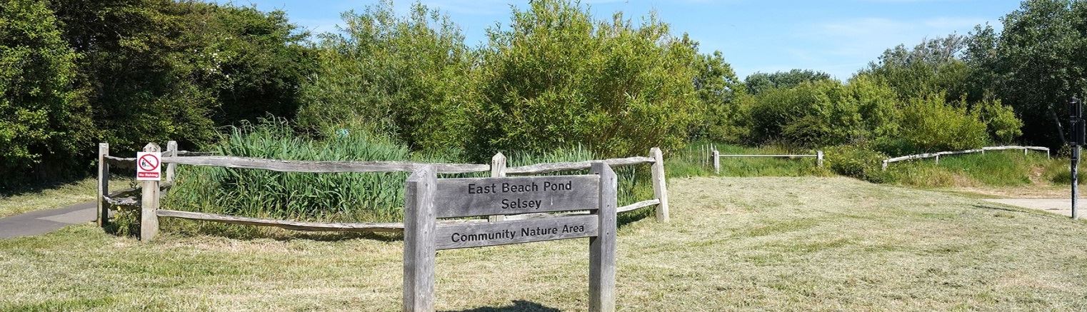 Wooden sign to East Beach Pond Selsey a community nature area