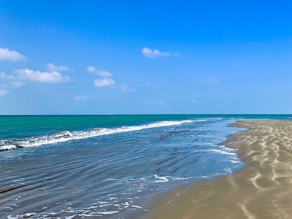 The sea, sky and sand at Oval Field Beach at low tide 