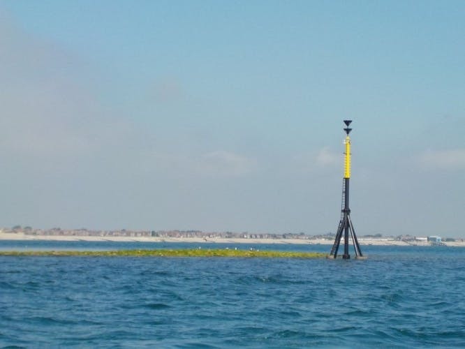 Mixon Hole Cardinal Marker, with the mixon to the side far out at sea off the coast of Selsey