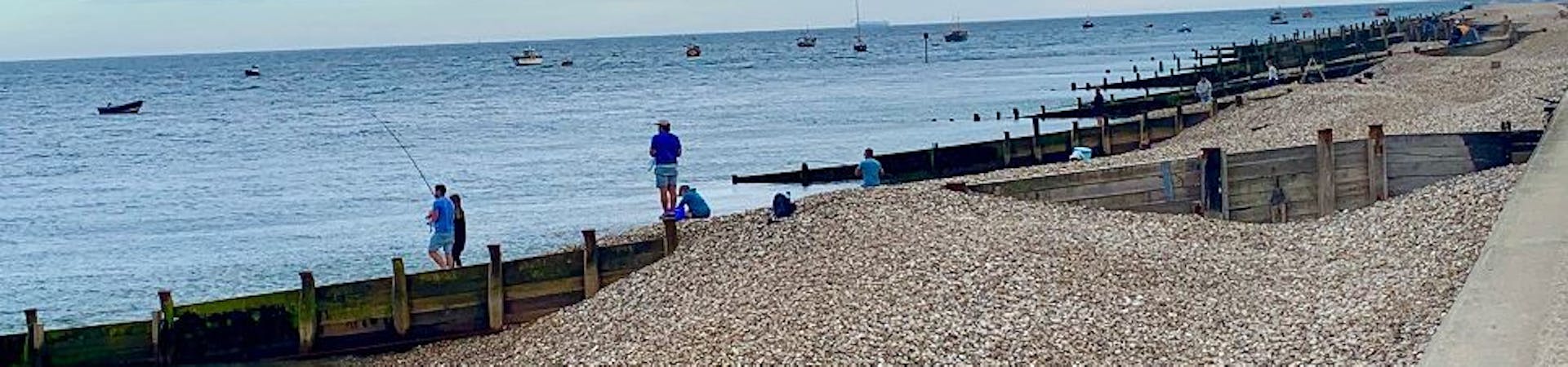 People gather to fish off of East Beach, Selsey