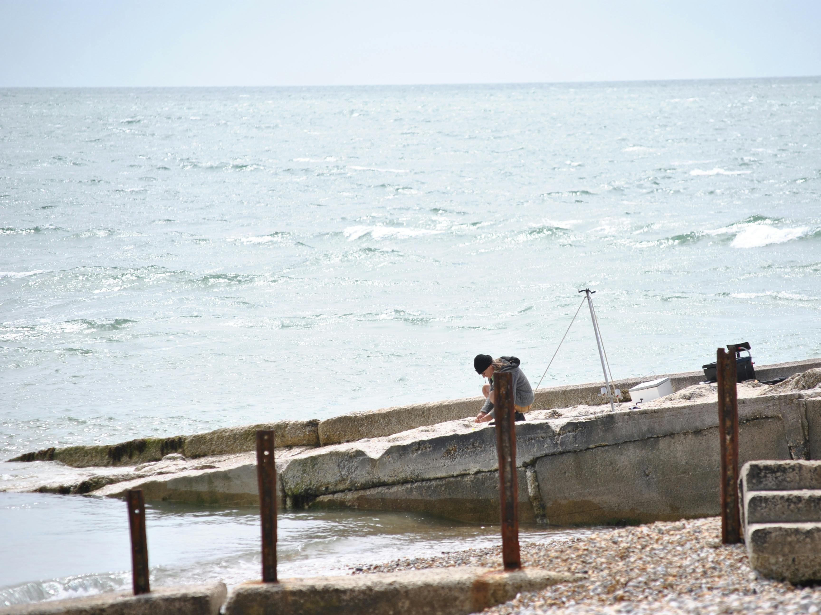 Sea angler getting his bait ready for fishing at Selsey Bill 