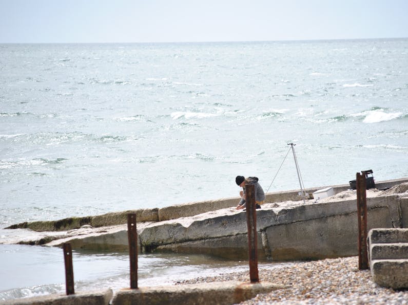 Sea Angler at the Selsey Bill Sea angler getting his bait ready for fishing at Selsey Bill