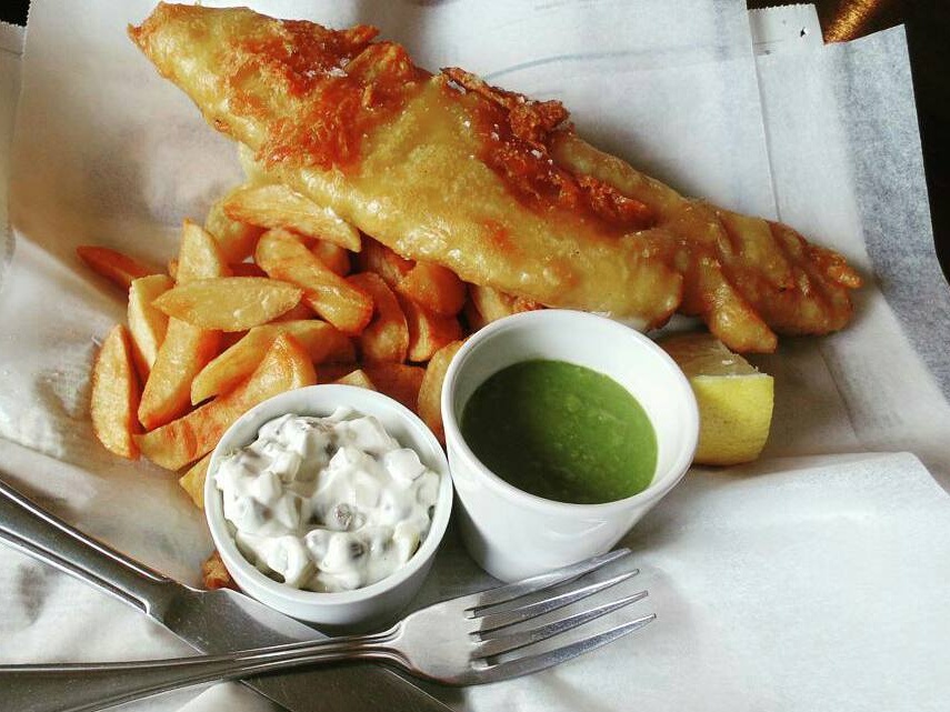 Plate of fish and chips with homemade tartare sauce and mushy peas