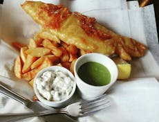 Plate of fish and chips with homemade tartare sauce and mushy peas