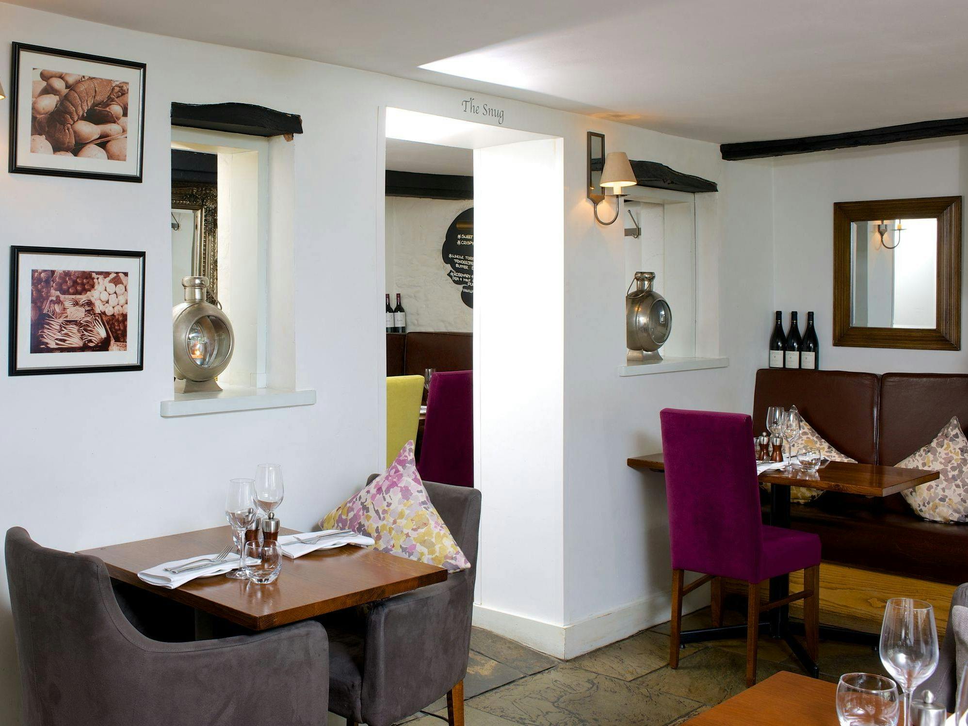 The sumptuous dining room at the crab and lobster with velvet chairs and images of seafood on the walls. 
