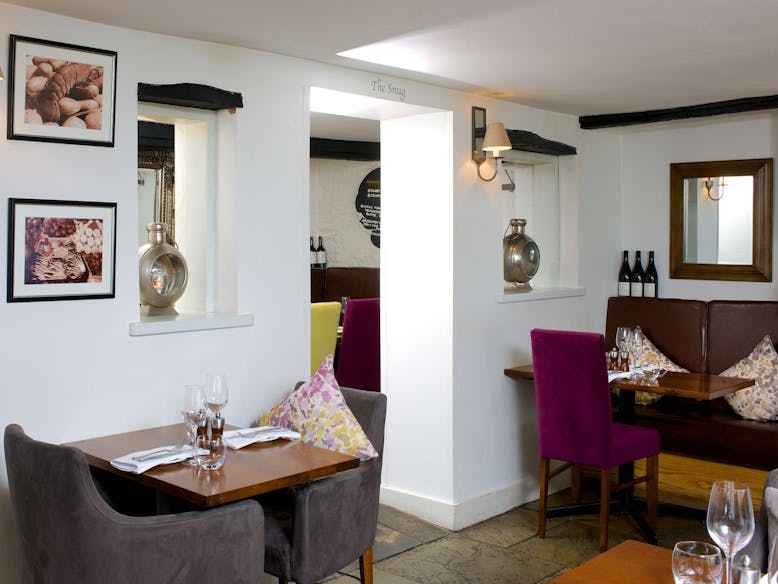 Inside the Dinning Area of the Crab and Lobster, Sidlesham The sumptuous dining room at the crab and lobster with velvet chairs and images of seafood on the walls.