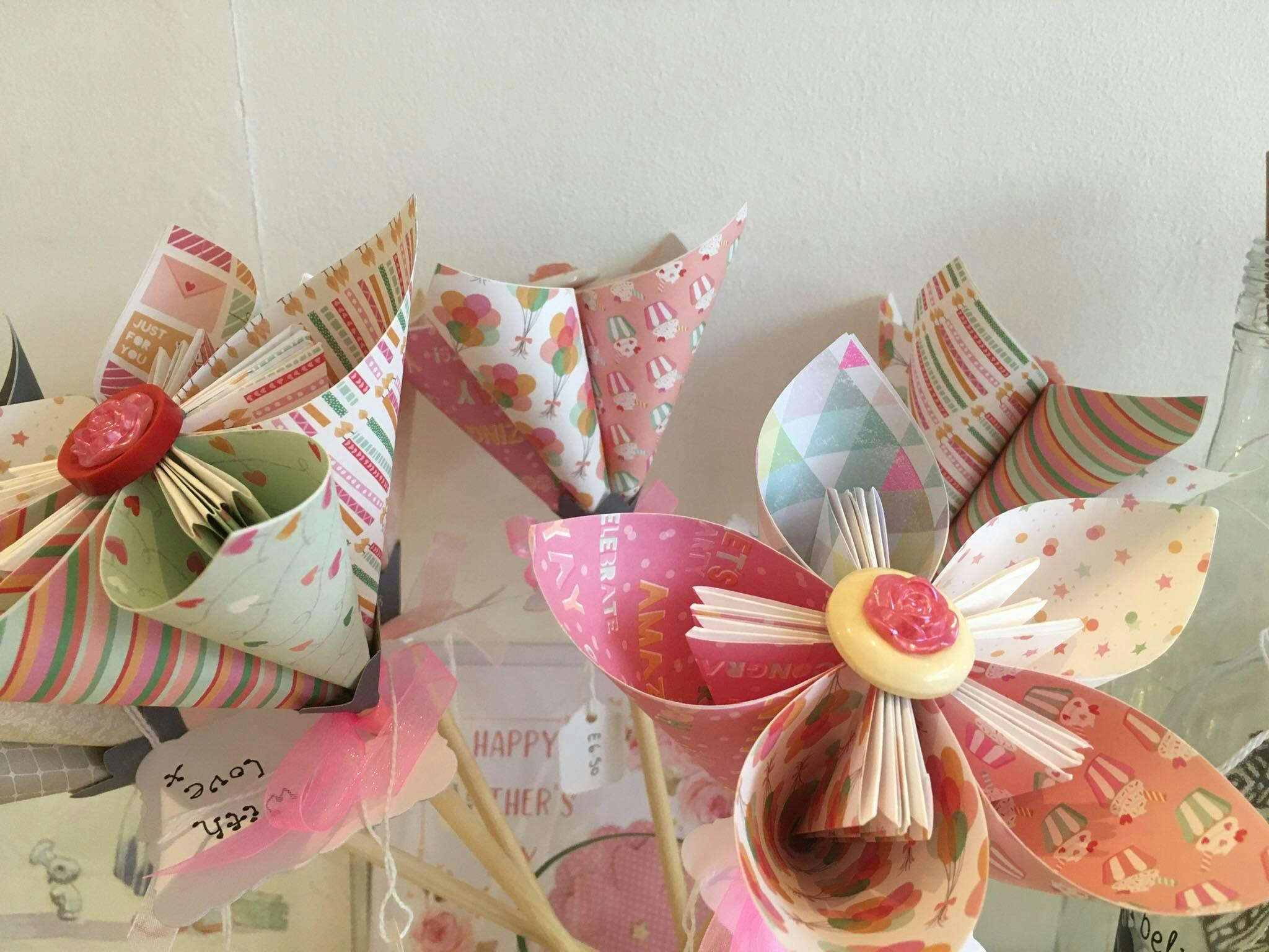 Paper flowers made from wrapping paper, a delightful example of different craft items on sale at THE SHOP