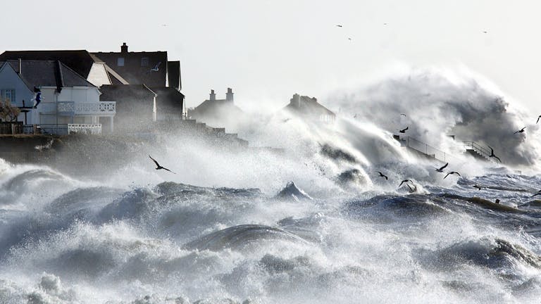 Storm Eleanor forces the waves to batter against the houses on the sea front at Selsey 