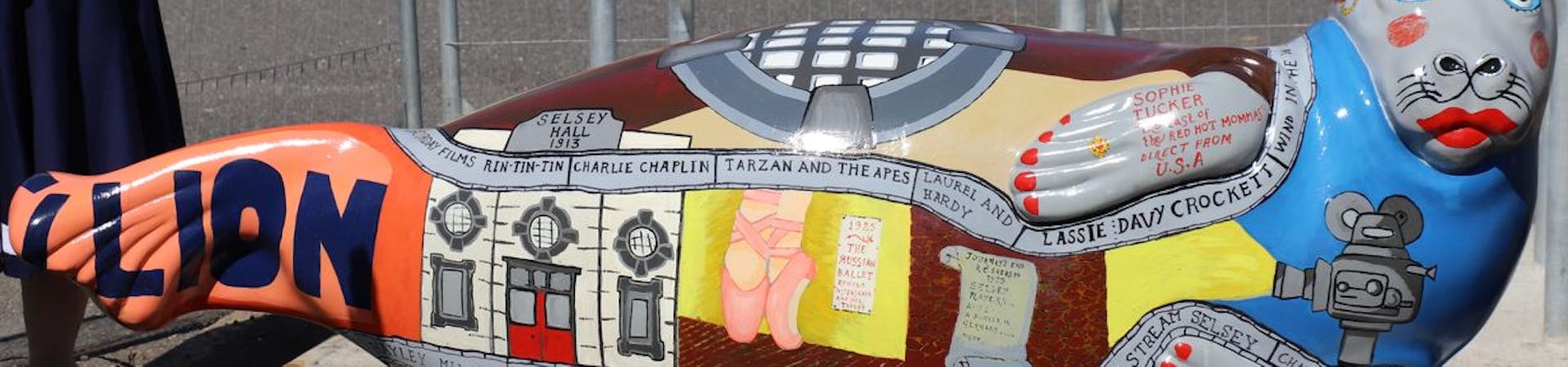 Fibregalss seal painted with imagery to celebrate Selsey's Pavillion and the early 20th Century performer Sophie Tucker. Designed by Freya Kate Betteridge with the seal's head added by Pamela Howard OBE